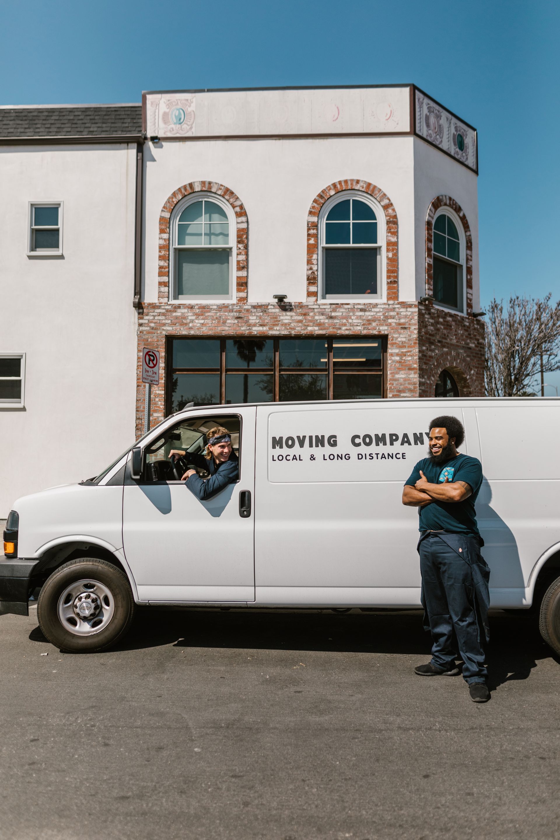 Moving crew standing at the back of their van before a job